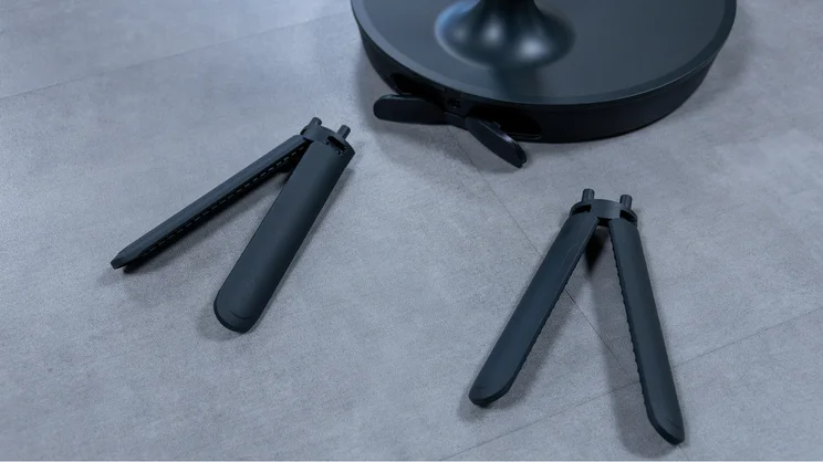 The Dimplex DuoCool 2-in-1 fan's legs, removed from the pedestal base and laid on the floor
