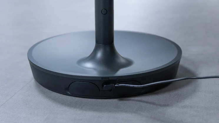 A closeup of the Dimplex DuoCool 2-in-1 fan's pedestal base, plugged in