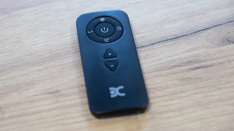 The Dimplex Flexblade tower fan's remote control on an office table