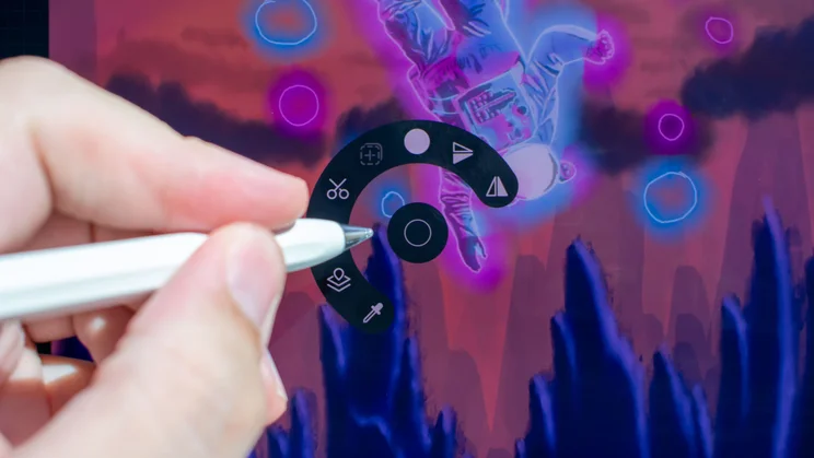 Hand holding a stylus with a quick menu on the tablet display