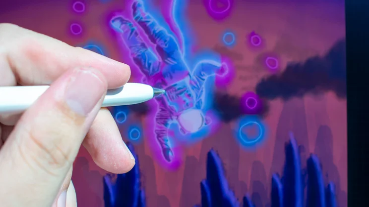 Hand with a stylus drawing digital art