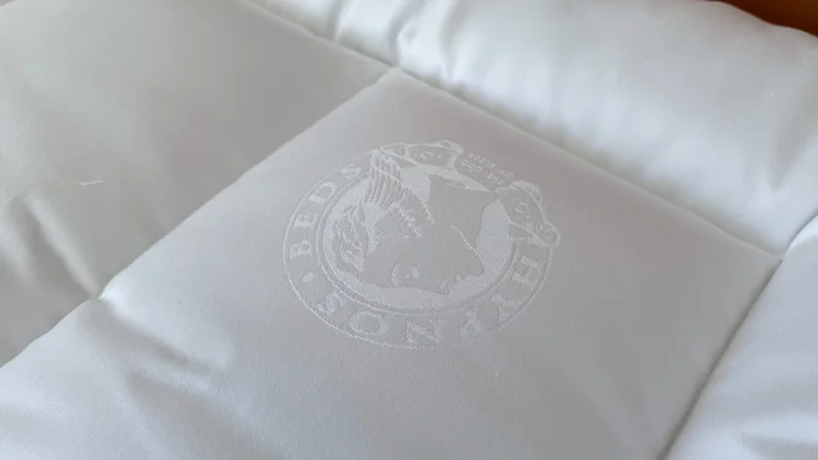 A closeup of the Hypnos logo on the surface of the Hypnos Inspired By Nature Wool and Latex Enhancer