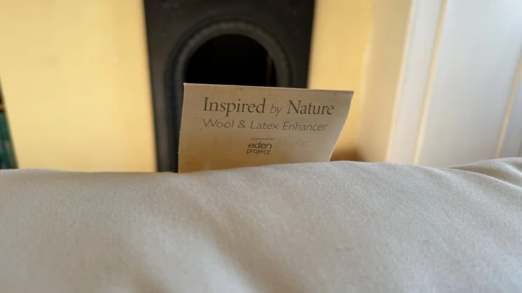 A closeup of the label on the edge of the Hypnos Inspired By Nature Wool and Latex Enhancer