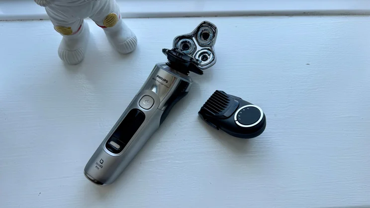 Philips i9000 Prestige Ultra - wide shot of shaver with attachments on window sill