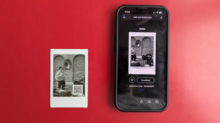 A bird's eye view of an Instax Mini Evo Cinema print, alongside a phone showing the scanned print as a video