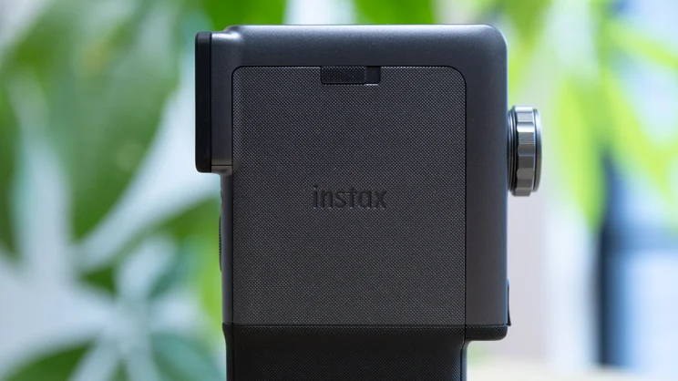 A closeup of the side of the Instax Mini Evo Cinema, showing its closed film compartment