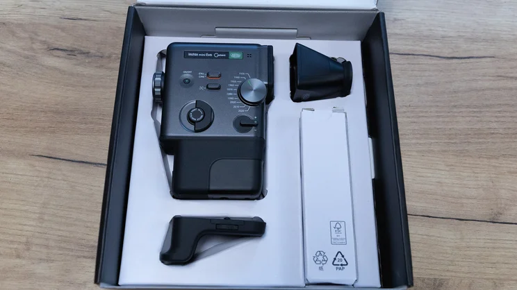 The Instax Mini Evo Cinema, and attachments, in its box
