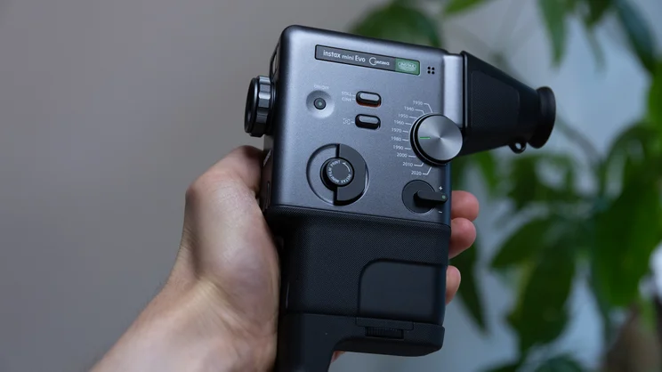 The Instax Mini Evo Cinema, held in the hand