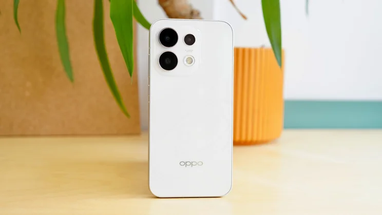 Oppo Reno 16 Pro in front of a plant, rear view