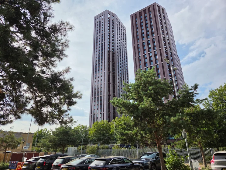 Two tower buildings surrounded by trees