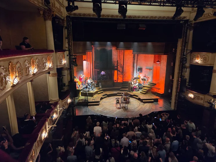 A band playing on stage in a theatre