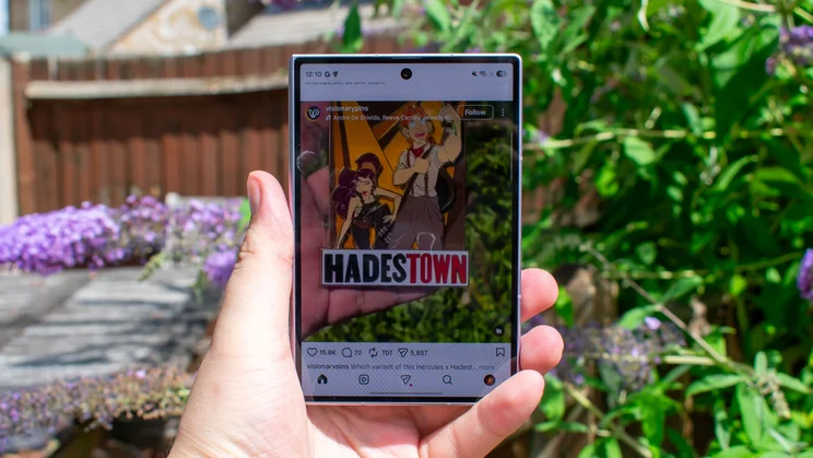 Samsung Galaxy Z Fold 8 in hand, displaying a social media feed