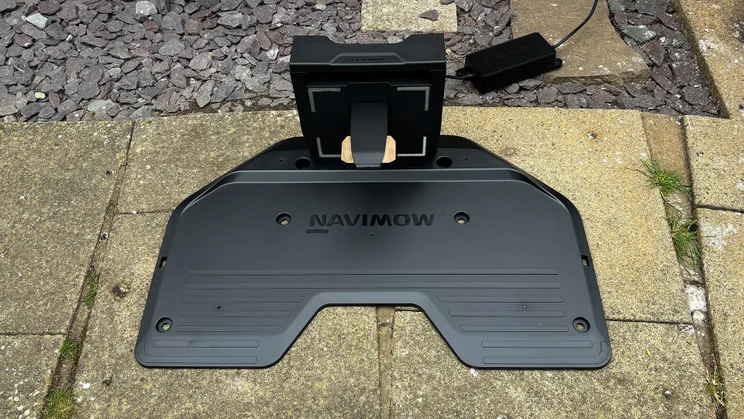 Viewed from above, the base dock for the Segway Navimow X430 robot lawnmower