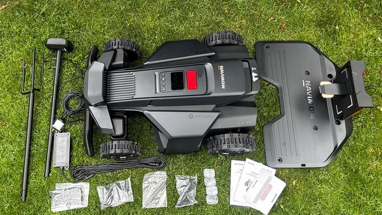 A bird's eye view of the Segway Navimow X430 robot lawnmower, accessories and parts