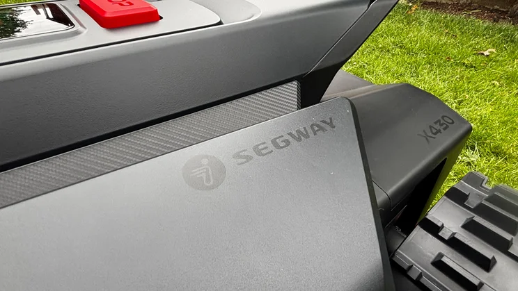 A closeup of the logo badge on the side of the Segway Navimow X430 robot lawnmower