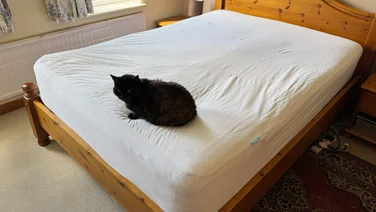 The Simba TripleShield Bamboo mattress protector on a mattress in a bedroom