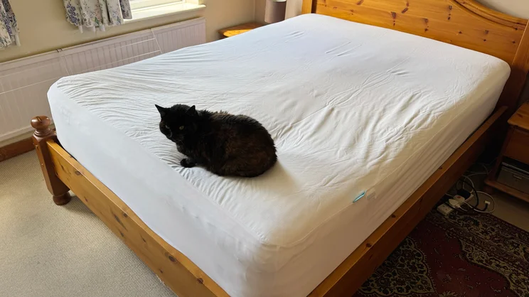 The Simba TripleShield Bamboo mattress protector on a mattress in a bedroom