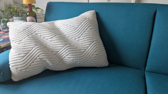 The Tempur Cloud SmartCool pillow placed on the corner of a blue sofa