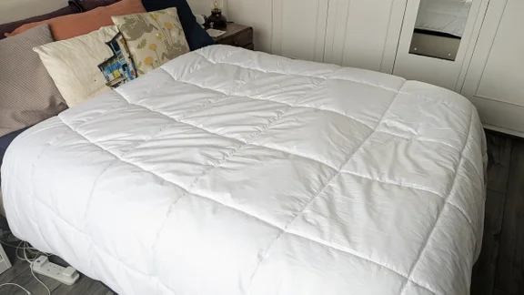 The Tempur Luxe Fibre Cooling Duvet on a mattress in a bedroom