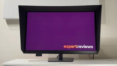 The Dell UltraSharp U3226Q pictured from the front, with hood on