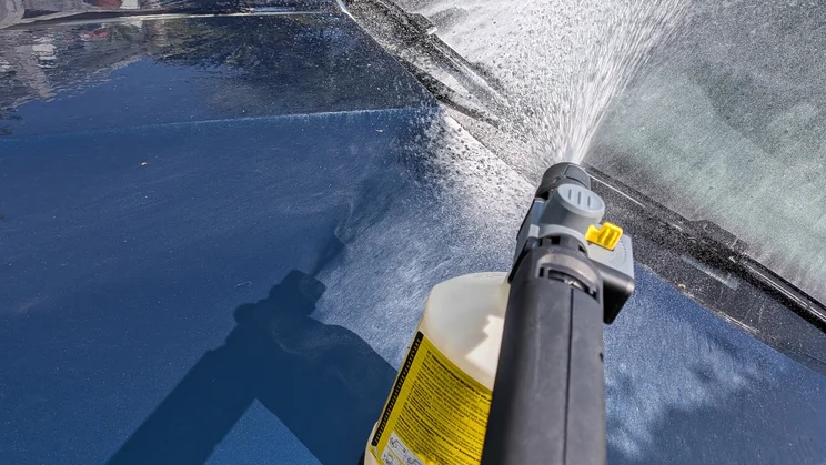 The Karcher K5 Comfort Premium pictured in action, cleaning a car