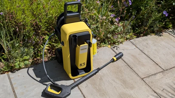 The Karcher K5 Comfort Premium pictured on a patio with vegetation in the background
