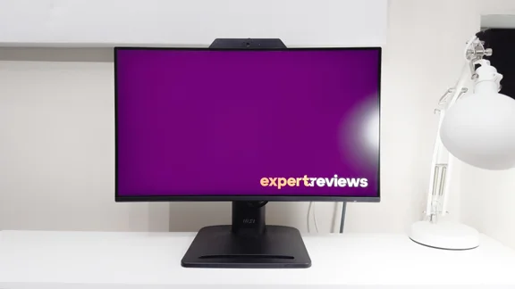 The MSI Pro MP242PMG monitor pictured from the front on a white desk showing the Expert reviews logo on screen