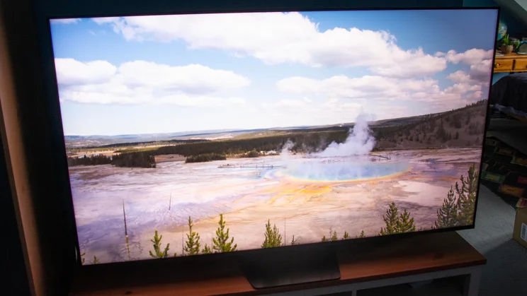 The Hisense UR8S RGB Mini LED TV displaying an image of a geothermal pool in Filmmaker Mode