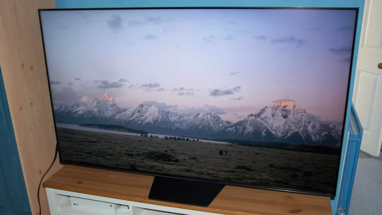 The Hisense UR8S RGB Mini LED TV displaying an image of a mountain range