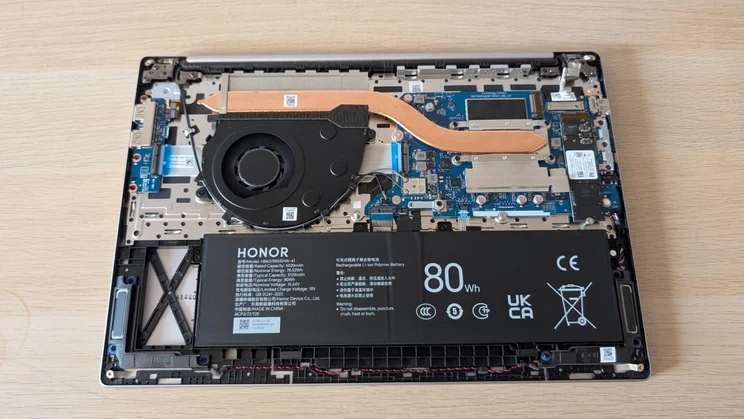 Top-down view of the Honor MagicBook 16 laptop with its base plate removed showing the internals