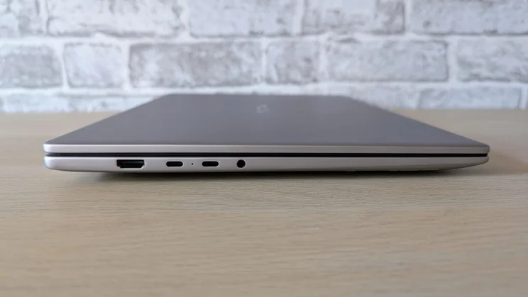 Side view of the Honor MagicBook 16 laptop with the lid closed showing its USB-C and HDMI ports and its headphone socket