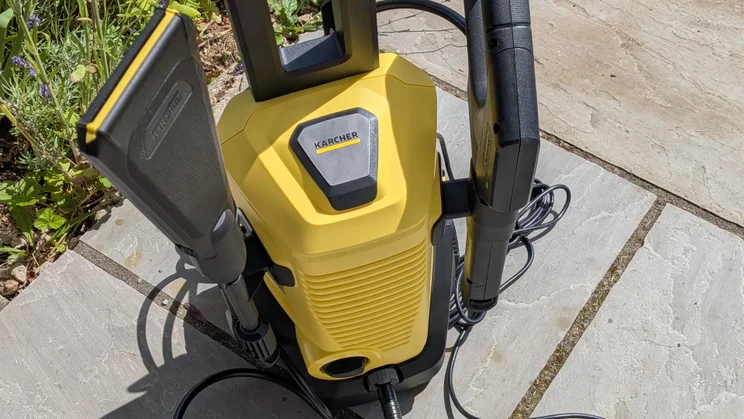 Close-up, top-down view of the K&auml;rcher K3 eco!Booster pressure washer on a patio