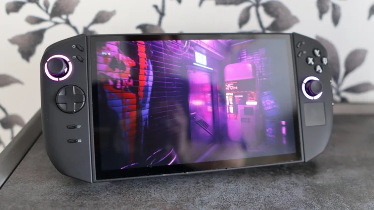 Front view of the Lenovo Legion Go 2 PC gaming handheld on its stand displaying a purple scene from Cyberpunk 2077