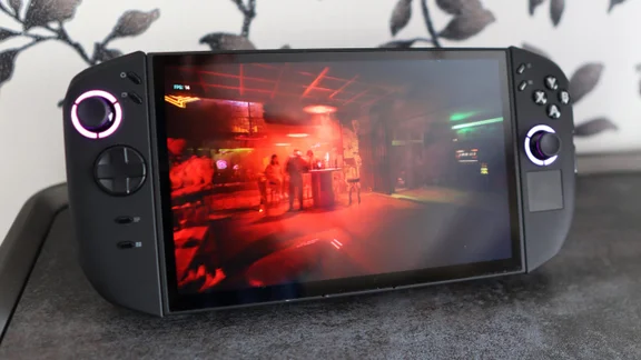 Front view of the Lenovo Legion Go 2 PC gaming handheld on its stand displaying a scene from Cyberpunk 2077