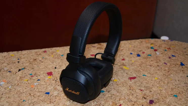 The Marshall Milton ANC on-ear headphones balanced upright on a cork table