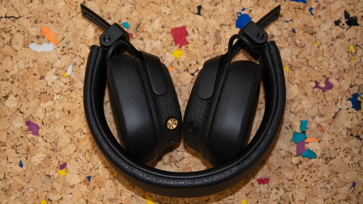 The Marshall Milton ANC on-ear headphones folded up on a cork table