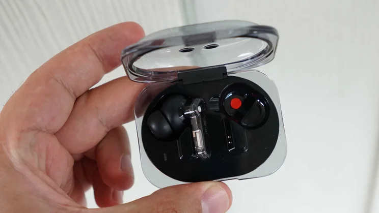 The Nothing Ear (3a) wireless earbuds charging case being held with its lid open and one earbud inside