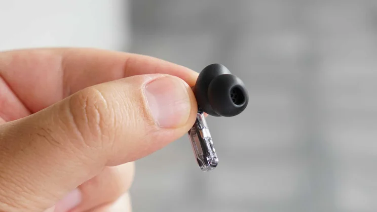 A single Nothing Ear (3a) wireless earbud being held in the fingertips of reviewer Simon Cocks