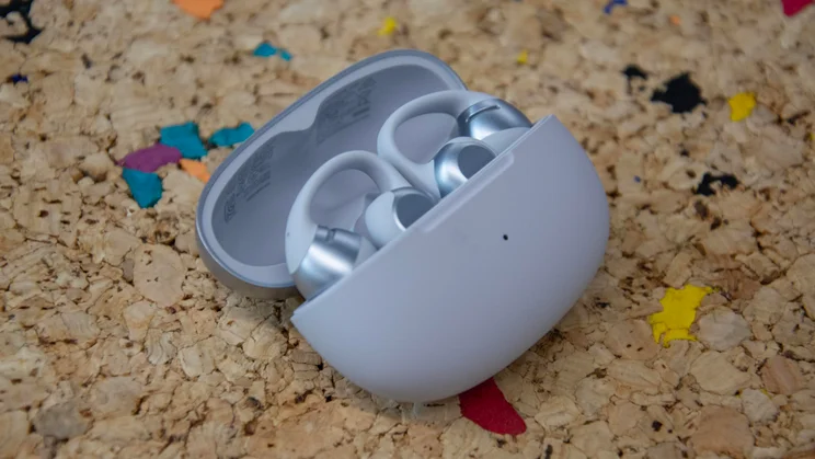 The charging case of the Shokz OpenDots 2 wireless earbuds with the lid open and the buds inside