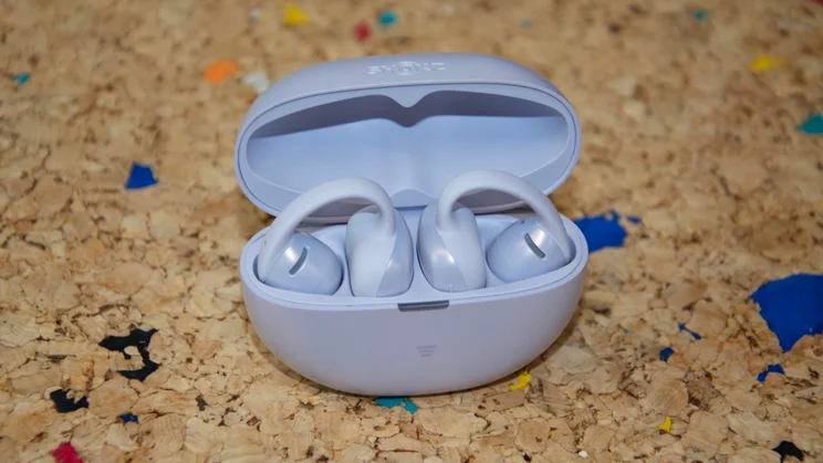 The Shokz OpenDots Air open-ear wireless earbuds in their charging case with the lid open