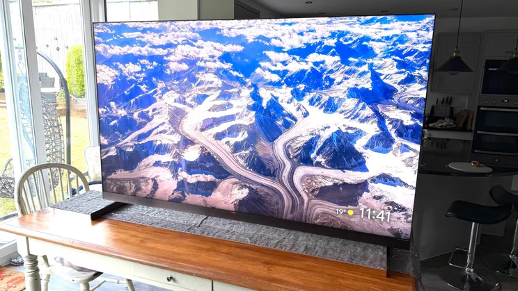 Right view of the TCL X11L SQD Mini LED TV displaying a mountainous screesaver