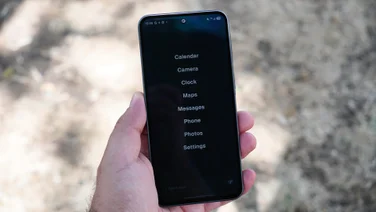 Balance Phone in hand, simple app list homescreen on the display