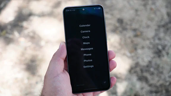 Balance Phone in hand, simple app list homescreen on the display