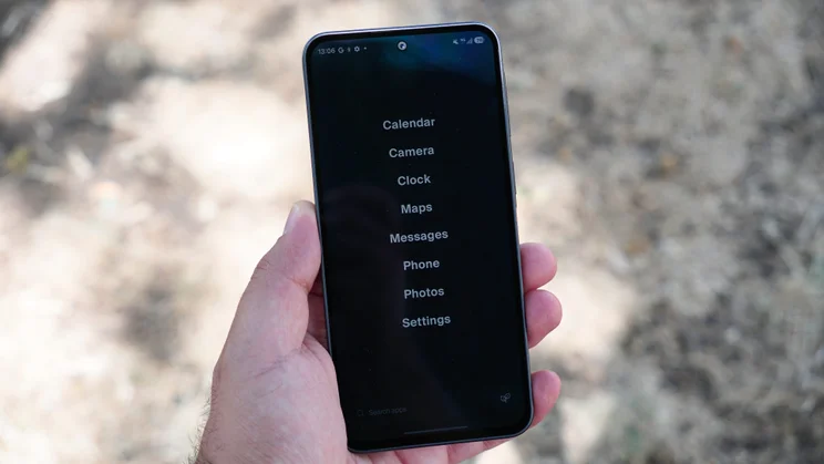 Balance Phone in hand, simple app list homescreen on the display
