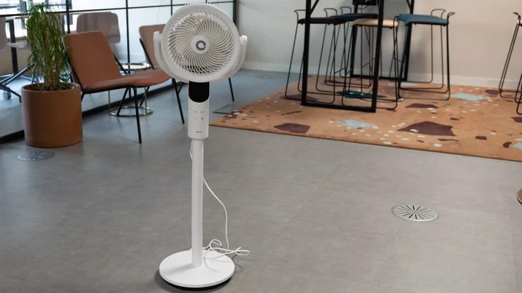 The Devola 8in Low Noise DC Pedestal fan on the floor of an office