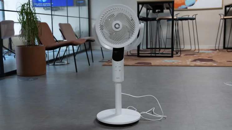 The Devola 8in Low Noise DC Pedestal fan on the floor of an office