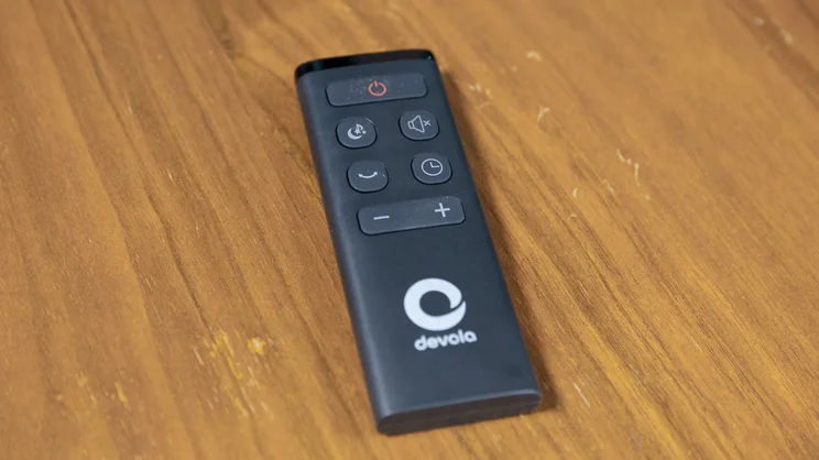 The Devola Platinum 38in DC Tower Fan's remote control on a wooden table