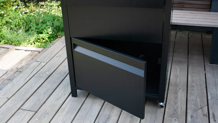 A closeup of the Dimplex Crossray eXtreme BBQ's internal storage, at the base of the BBQ stand