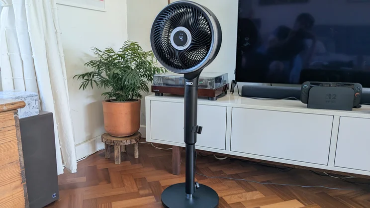 the Dreo Smart TurboPoly Fan 765S in its pedestal configuration, in a living room