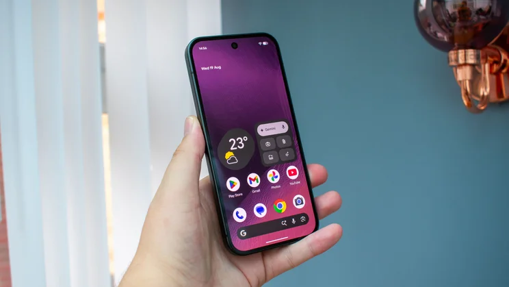 Google Pixel 11 in hand, front view